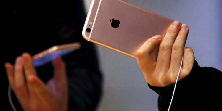 Apple, Tesla and Trump Media rise premarket;Exxon Mobil falls