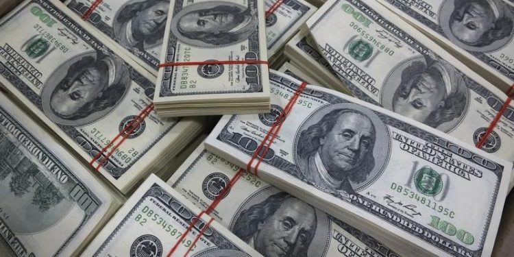 Dollar slips from highs; on track for hefty weekly gains